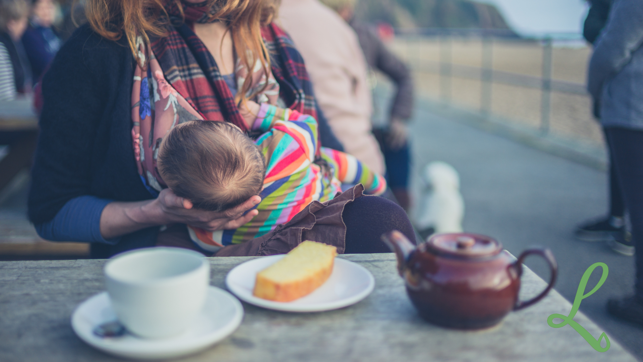 Woman sat at a cafe breastfeeding a baby