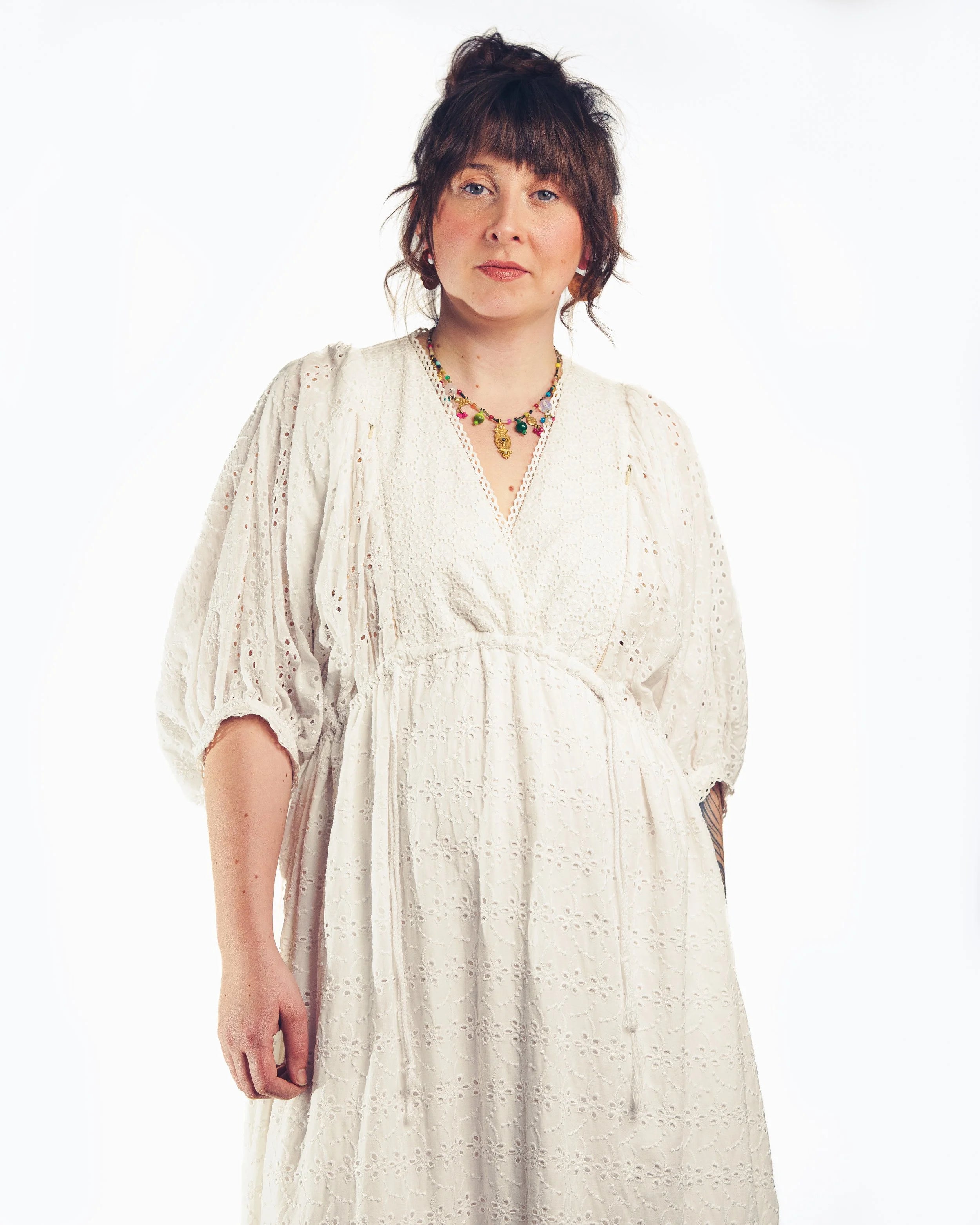 Sofia Maxi Dress white broderie — model wearing dress with necklace, with crossover V neck | Nomadic Mother | Latchette