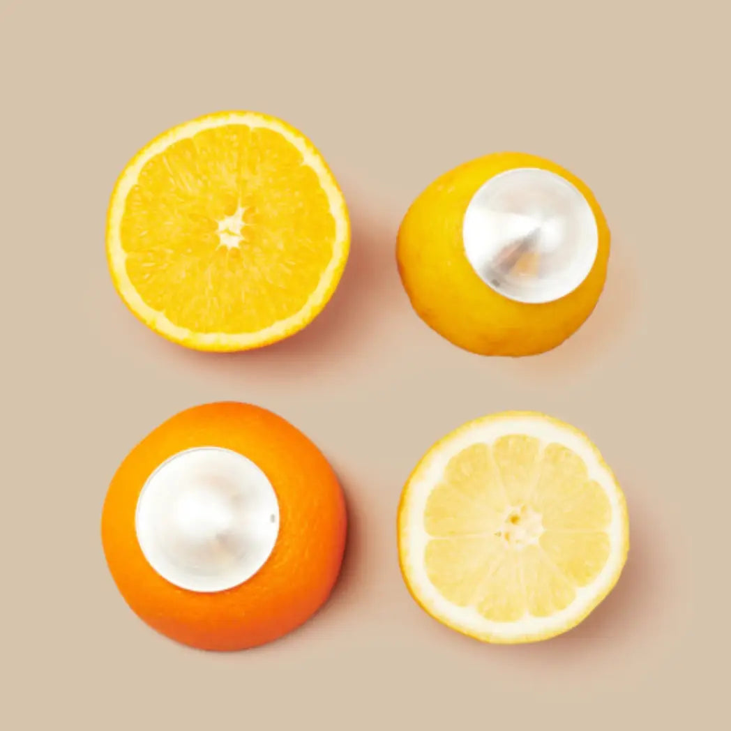 Four oranges, two halved and two whole, with silver cups on top
