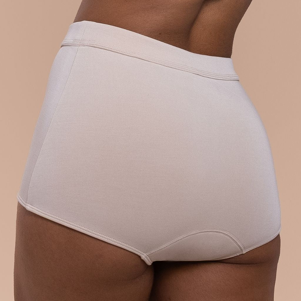 Beige underwear worn by a woman on a beige background
