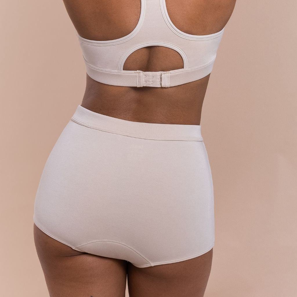 Woman wearing a beige bra and pants 