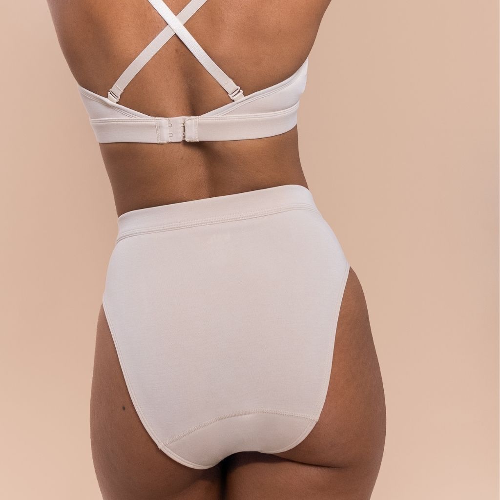 White lingerie set on a beige background