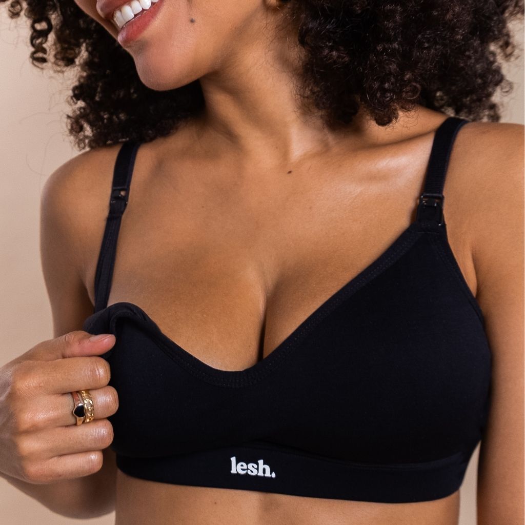 woman unclipping black nursing bra