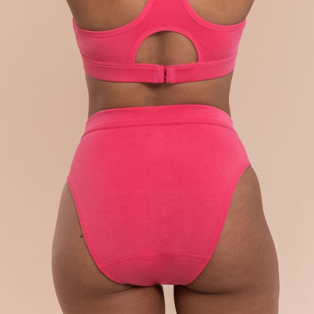 Pink underwear set on a beige background