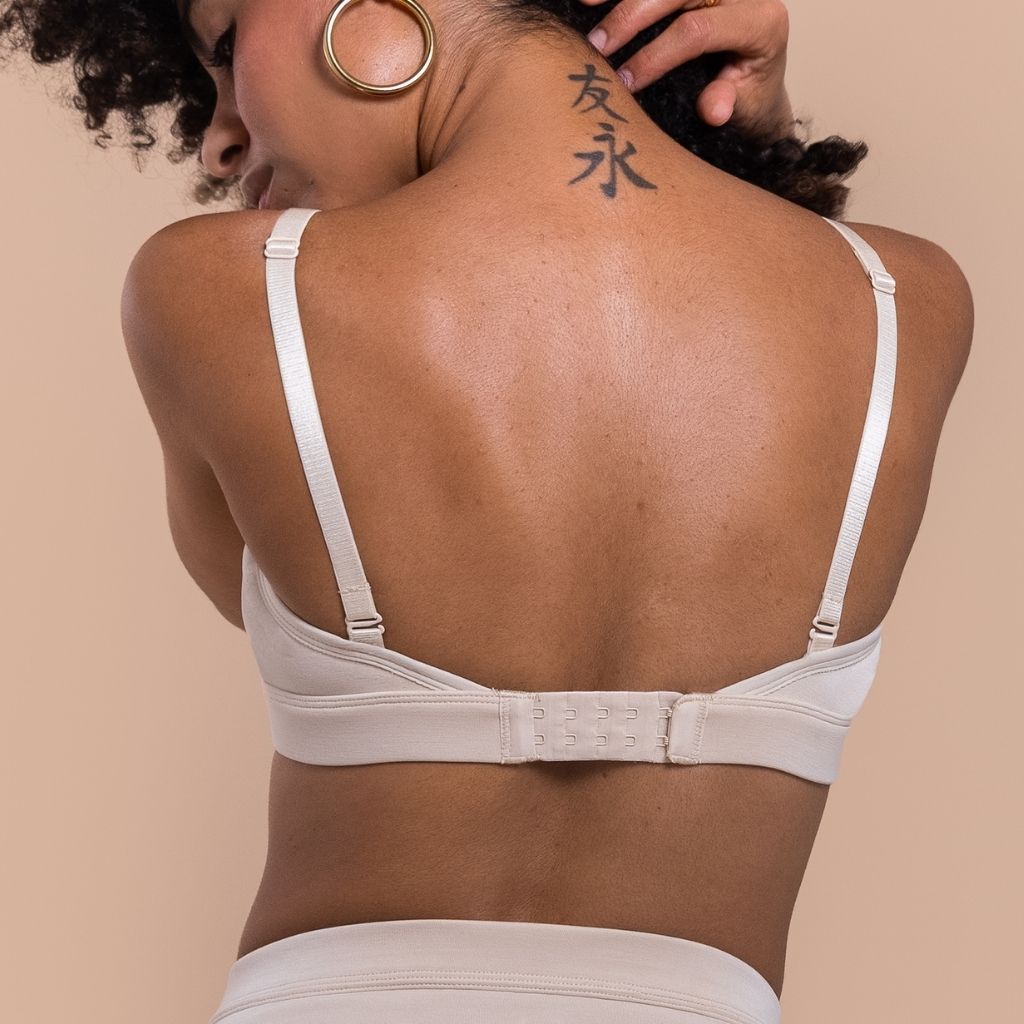 back of a woman wearing a white bra