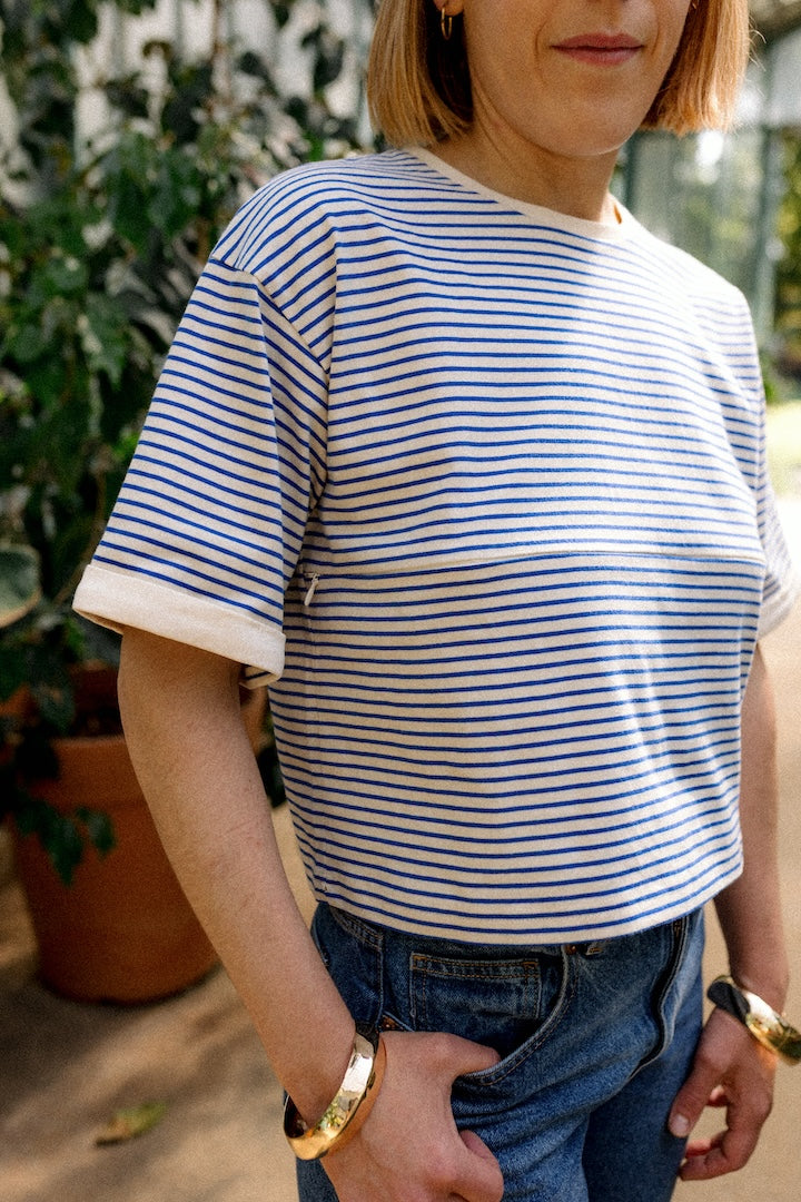 Woman wearing a blue and white striped T-shirt with a blurred background