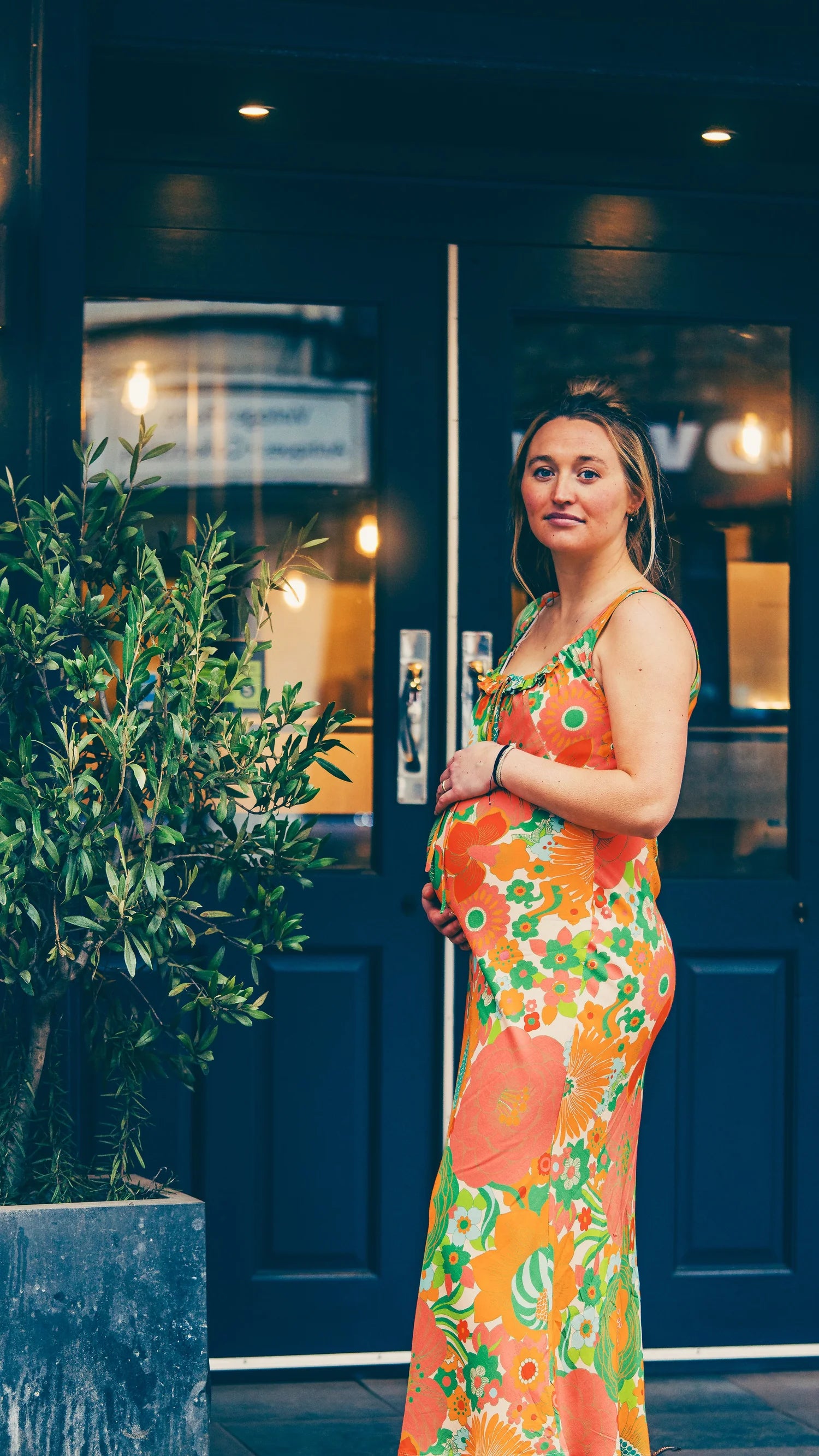Dali Midi Dress bold print — side view, bias cut drape accommodating growing bump | Latchette