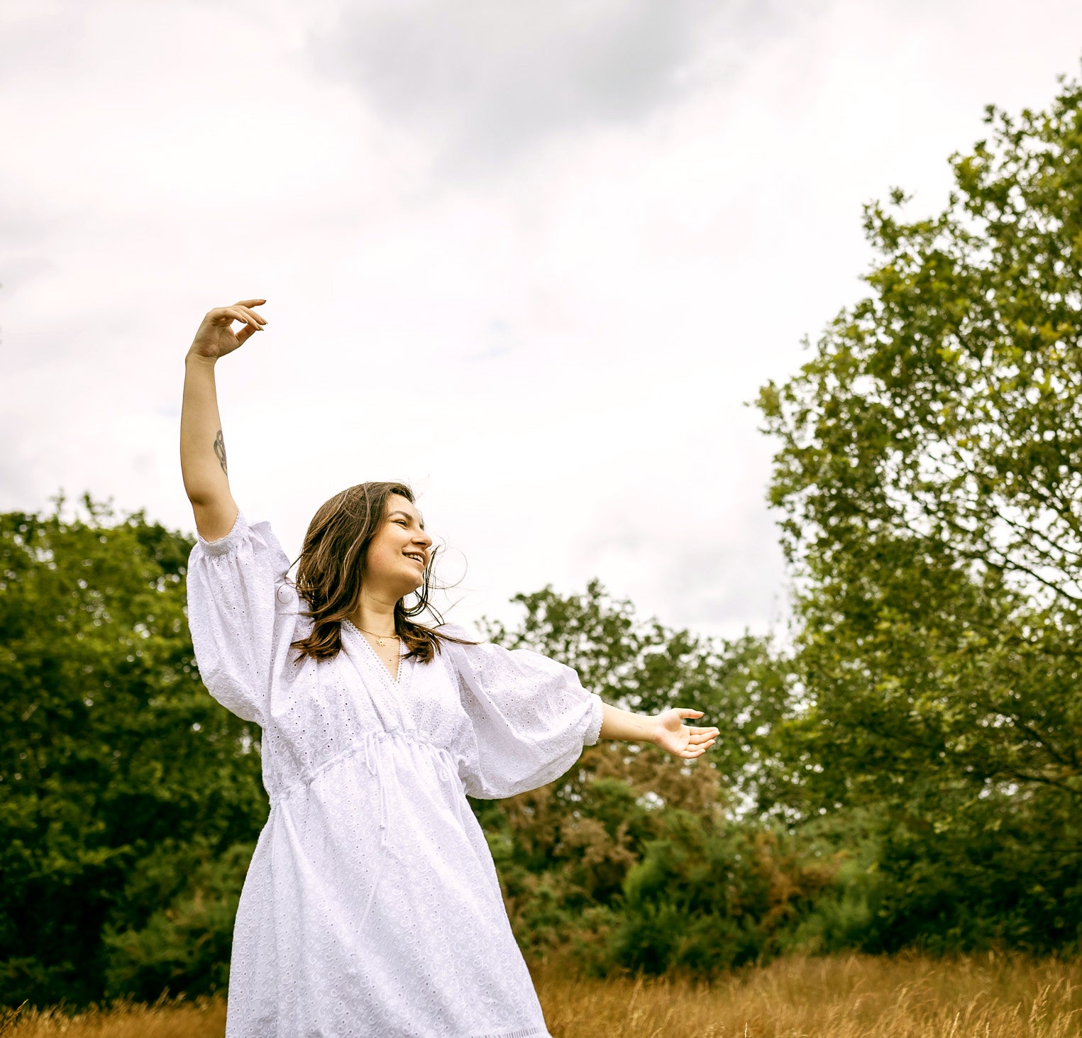 Sofia Maxi Dress white broderie — model wearing in pregnancy, with crossover V neck | Nomadic Mother | Latchette