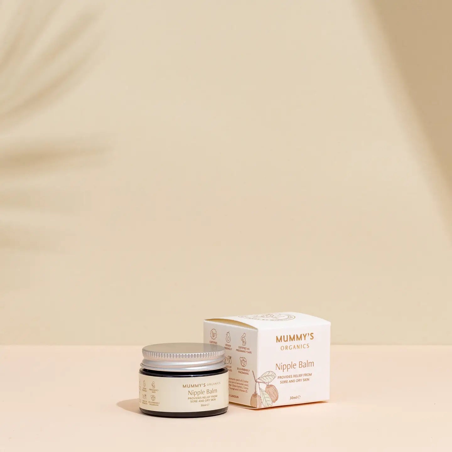 Mummy's Organics Nipple Balm jar and box on a beige background