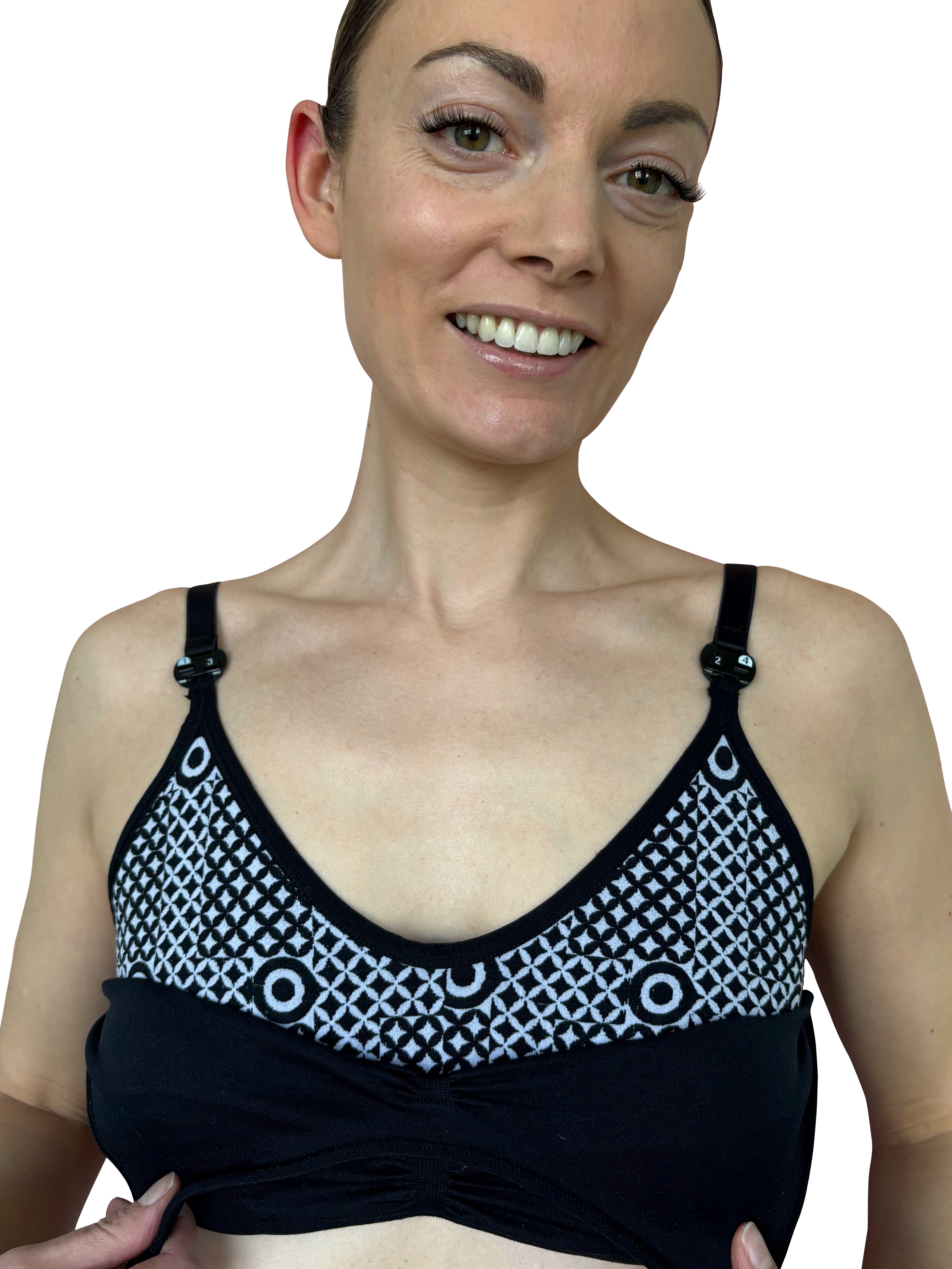 Woman wearing a black and white patterned bra against a plain background