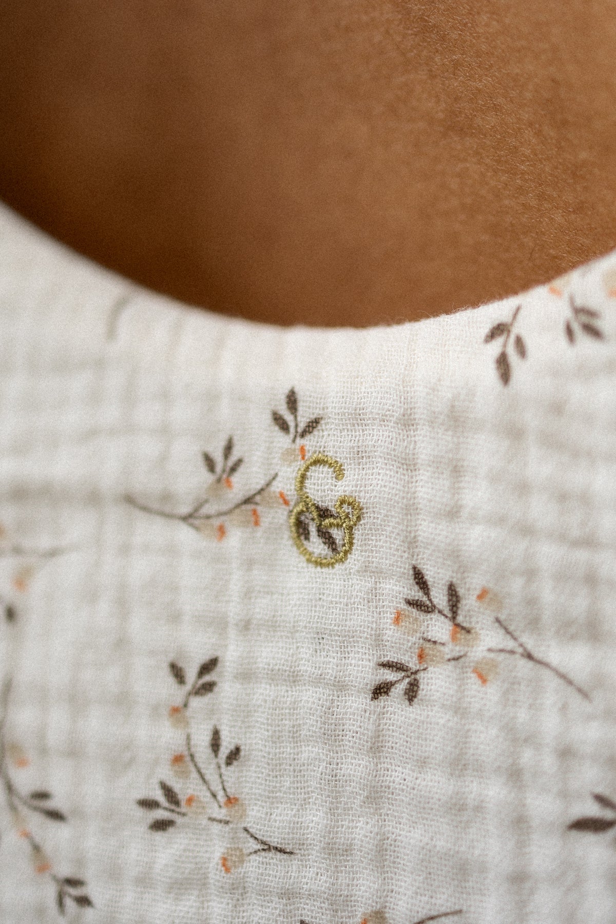 Close-up of a textured fabric with floral embroidery
