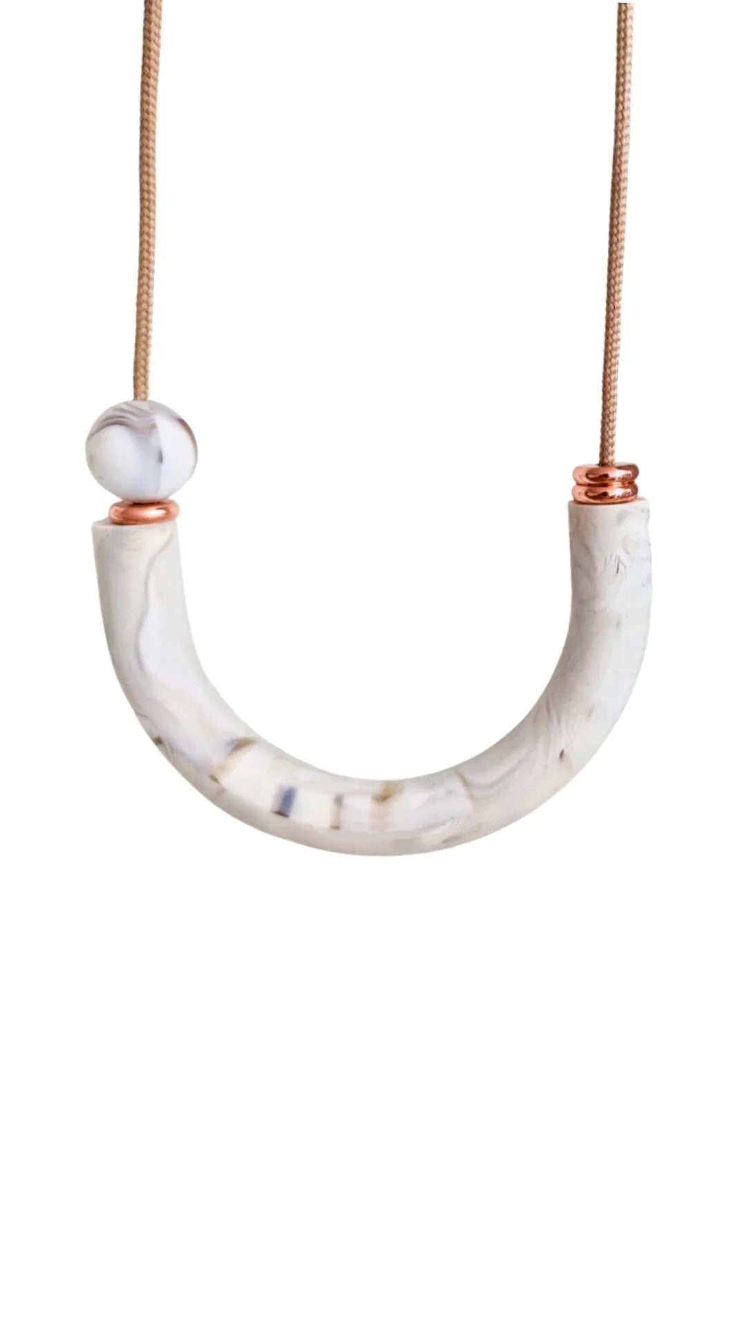 Necklace with a white marbled U-shaped pendant and rose gold accents on a white background